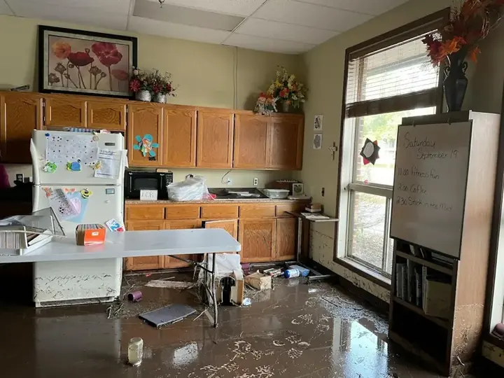 Muddy floodwater across a kitchen floor after a Central Texas flash flood