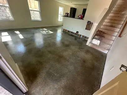 Bare concrete slab exposed after wet flooring was removed in a Cedar Park home